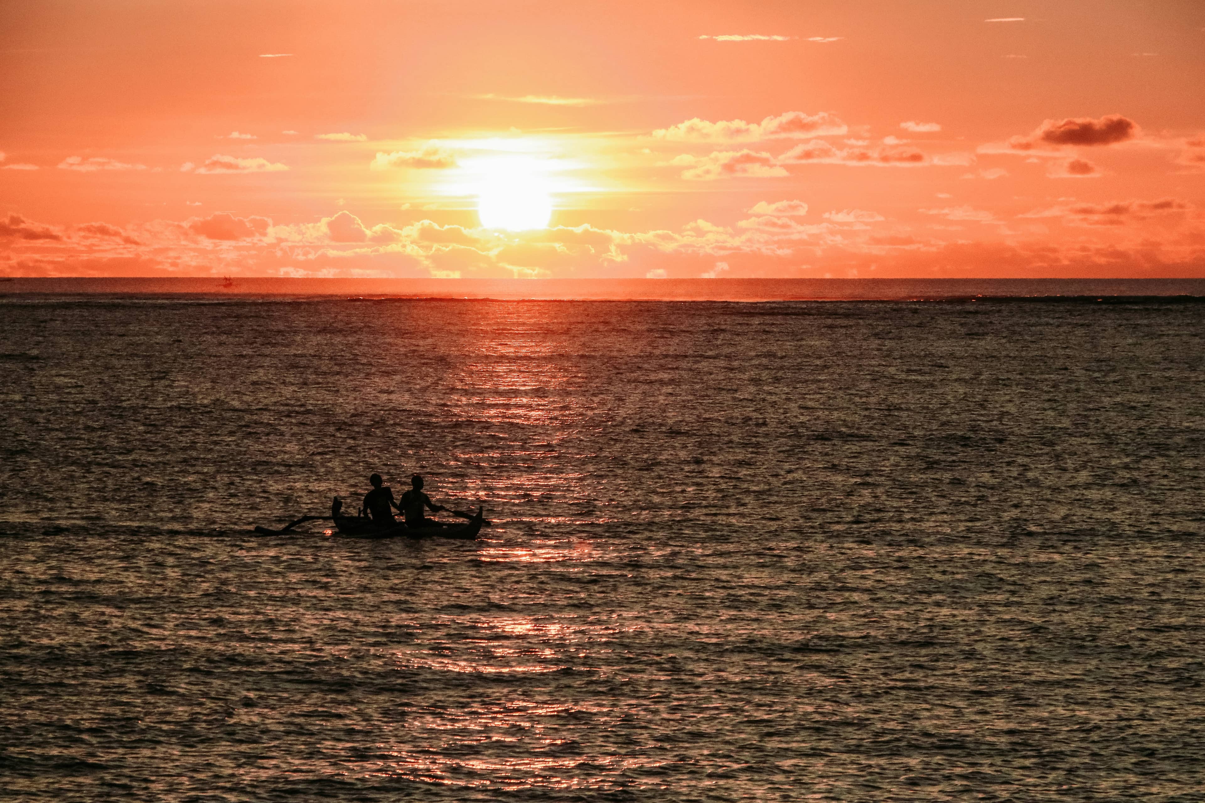 Silhouette of a boat on the water at sunset in Bali