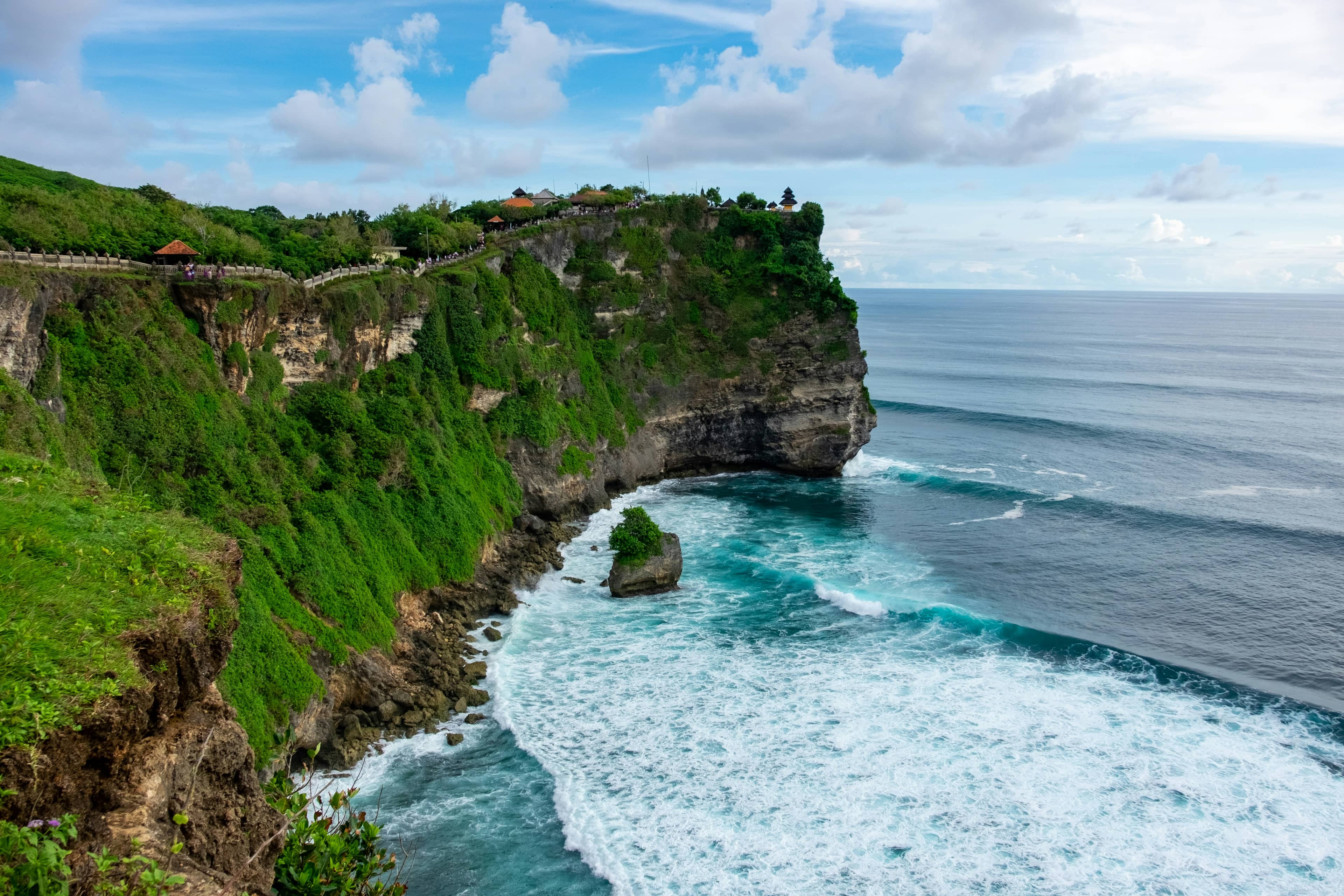 Dramatic clifftop coastline at Uluwatu, Bali, ocean waves against limestone cliffs